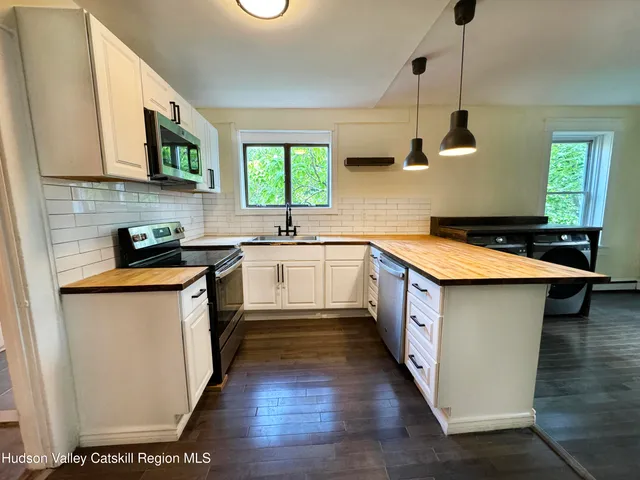 a view of a livingroom with wooden floor and a window