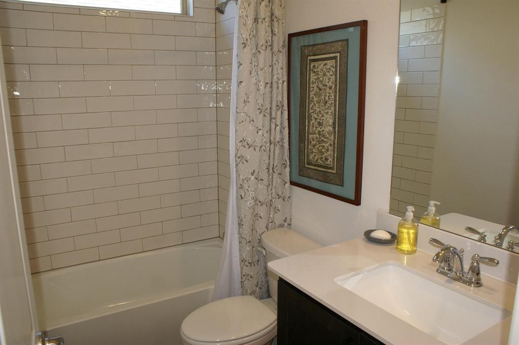 11132 Ranchera Drive Aubrey, TX 76227 - Photo 11 of 30 a bathroom with a sink toilet and shower