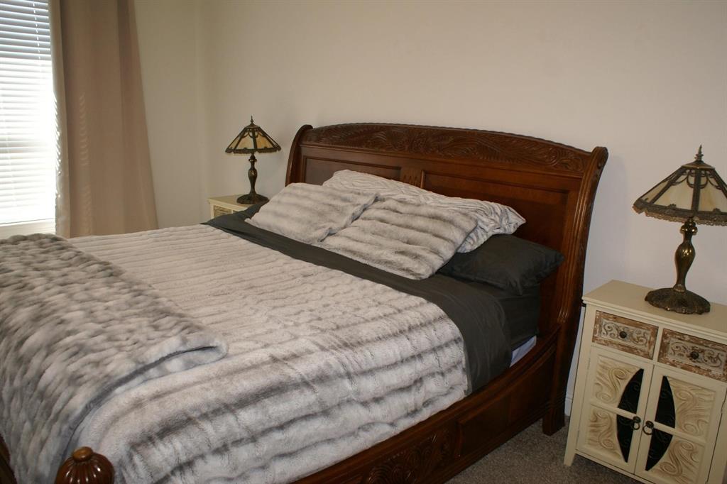 11132 Ranchera Drive Aubrey, TX 76227 - Photo 20 of 30 a bedroom with a bed and a flat tv screen