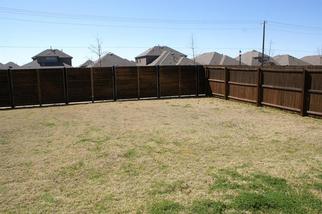 11132 Ranchera Drive Aubrey, TX 76227 - Photo 26 of 30 a front view of a house with wooden fence