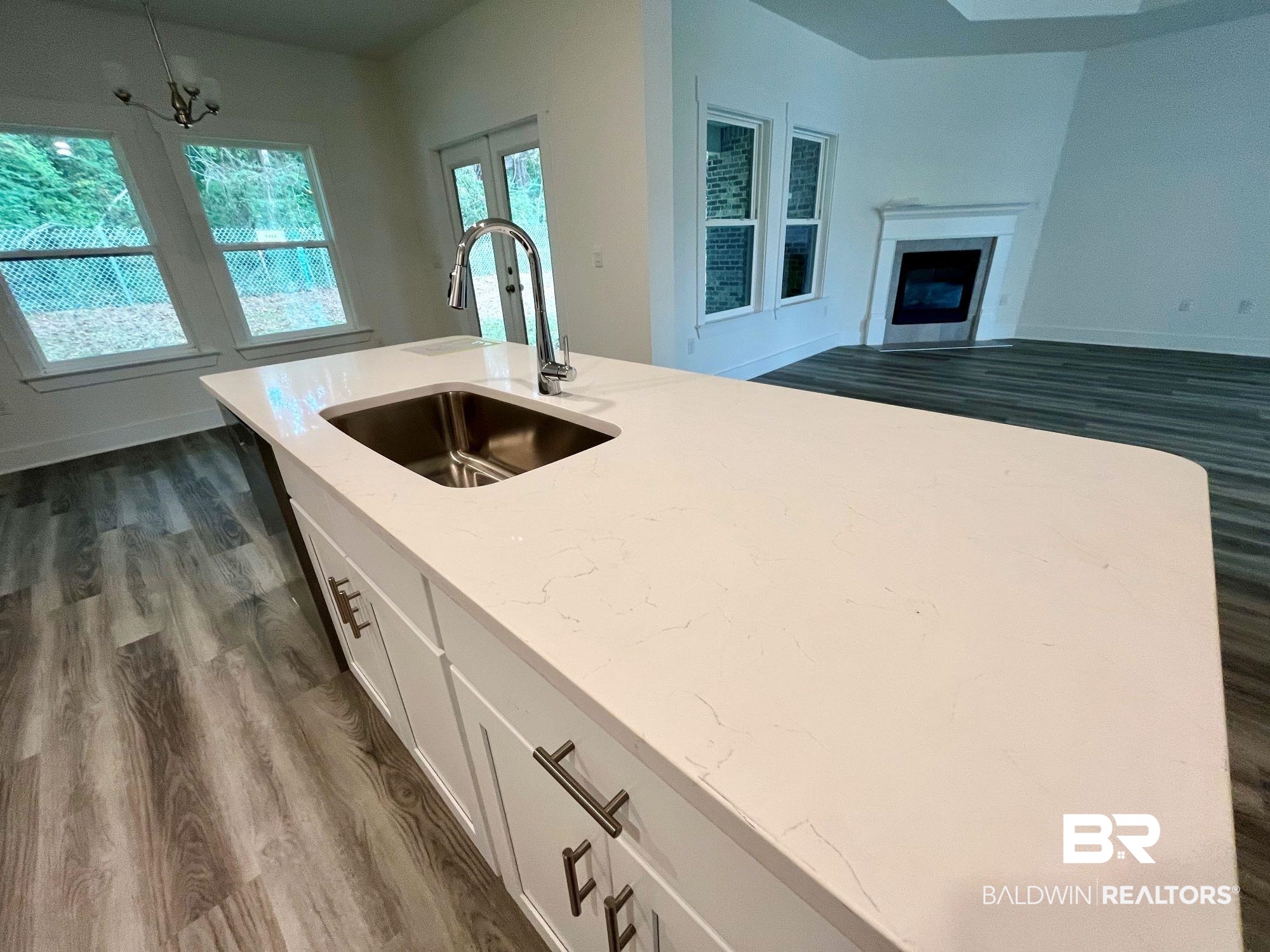 334 Barndling Street Fairhope, AL 36532 - Photo 16 of 34 Kitchen with dark hardwood / wood-style flooring, a notable chandelier, sink, light stone countertops, and white cabinetry
