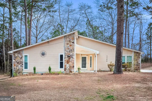 a view of a house with a yard and garage