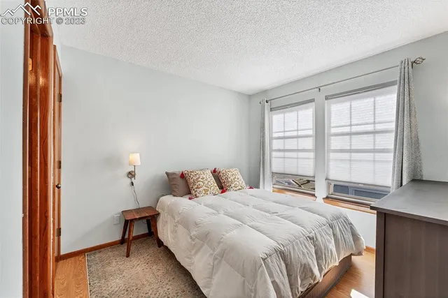 a bedroom with a bed and a wall painting