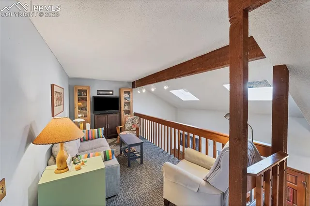 a view of a livingroom with furniture and chandelier