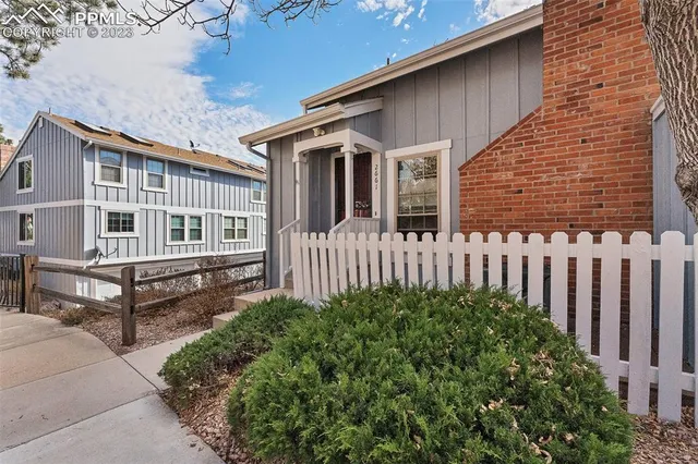 a front view of a house with balcony and garden