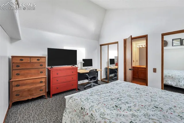 a living room with a bed and a dresser