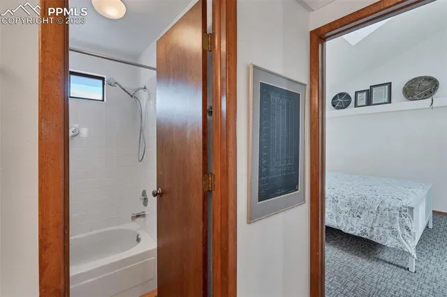 a en suite bathroom with a sink a mirror and shower