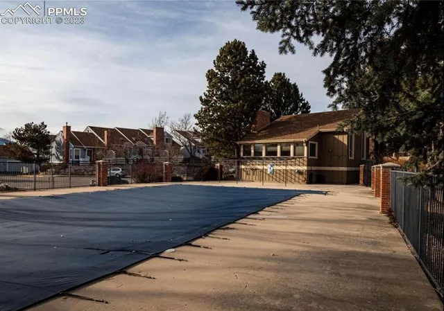a view of a yard with wooden fence