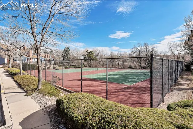 a view of a patio with iron fence