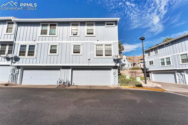 a front view of a house with a yard and table and chair