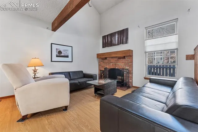 a living room with furniture wooden floor and a fireplace