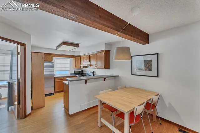 a open kitchen with stainless steel appliances granite countertop a stove and a refrigerator
