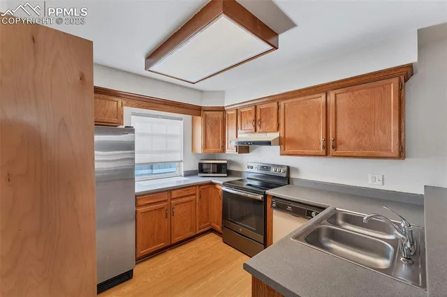 a kitchen with a sink appliances and cabinets