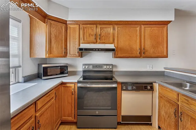 a kitchen with a stove and a sink