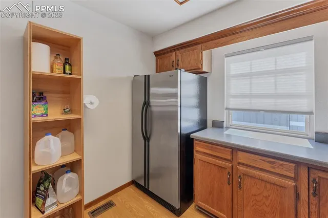 a kitchen with stainless steel appliances granite countertop a refrigerator and a sink