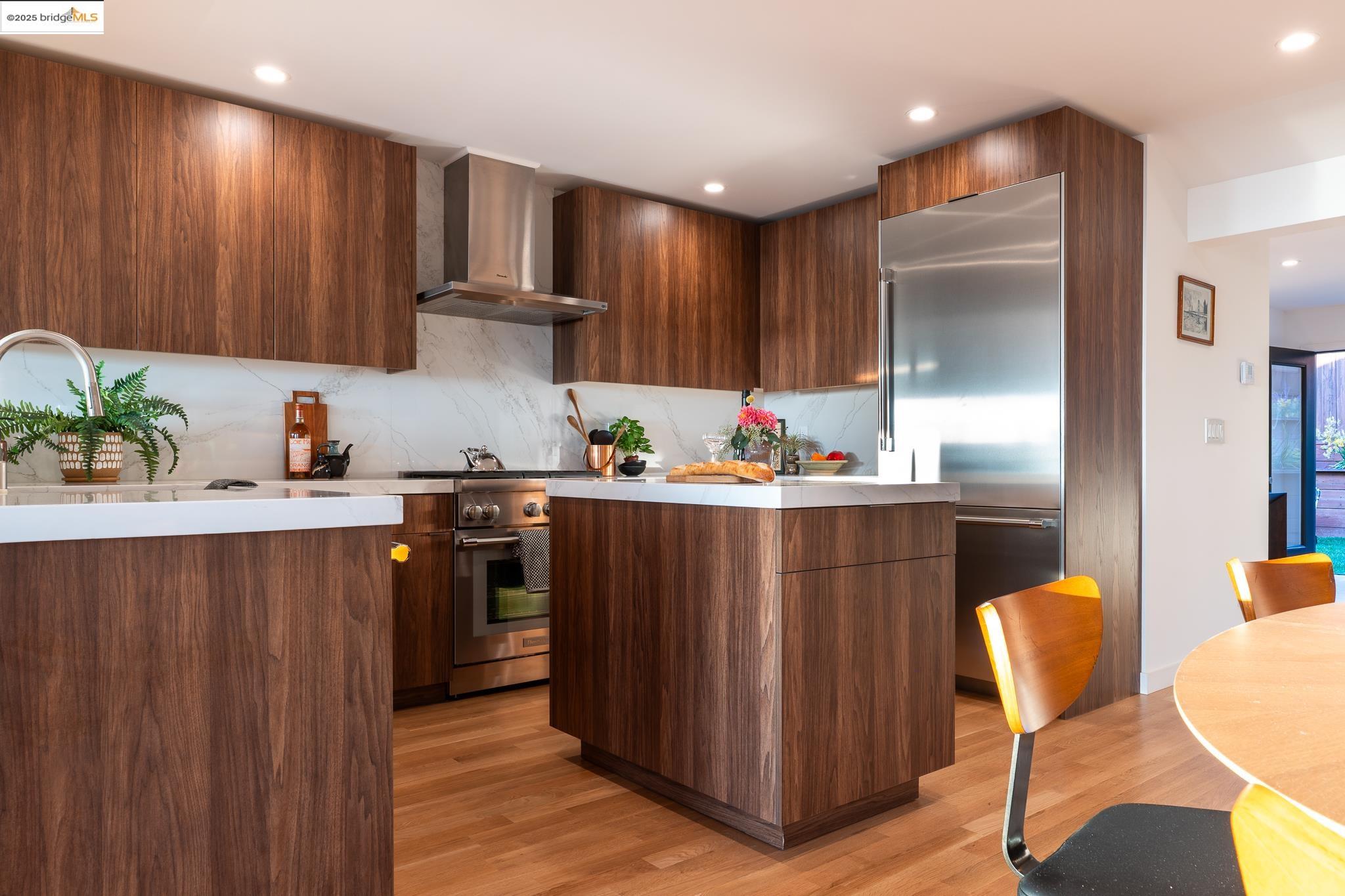 207 Cambridge Avenue Kensington, CA 94708 - Photo 16 of 47 a kitchen with stainless steel appliances granite countertop a refrigerator and a stove top oven