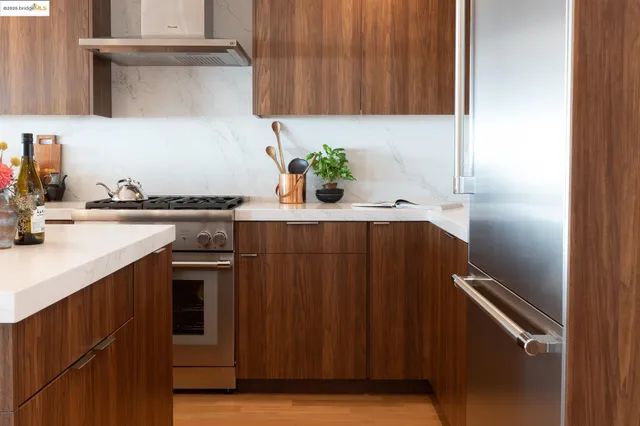 a kitchen with granite countertop a sink cabinets and stainless steel appliances