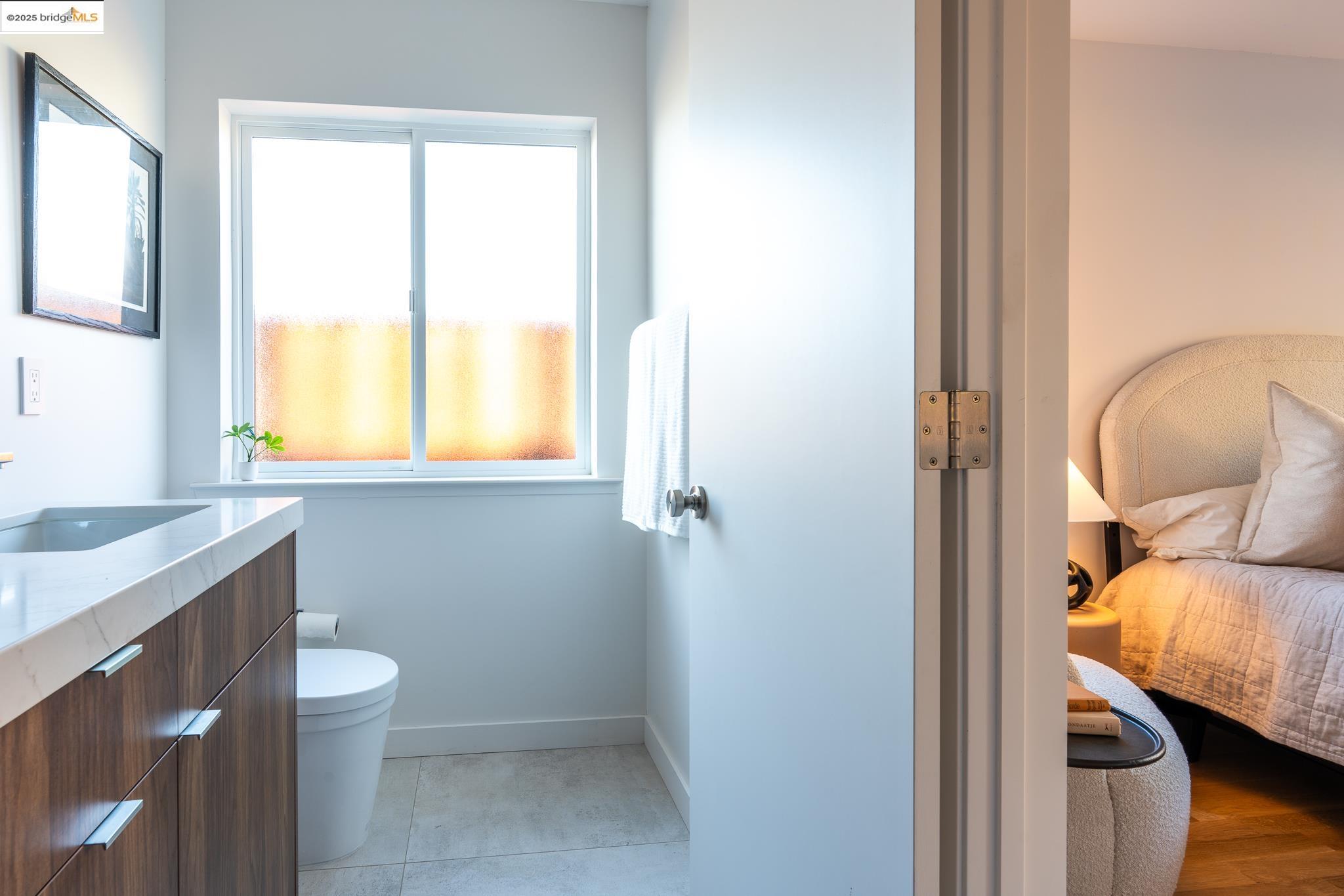 207 Cambridge Avenue Kensington, CA 94708 - Photo 26 of 47 a bathroom with a toilet sink and mirror