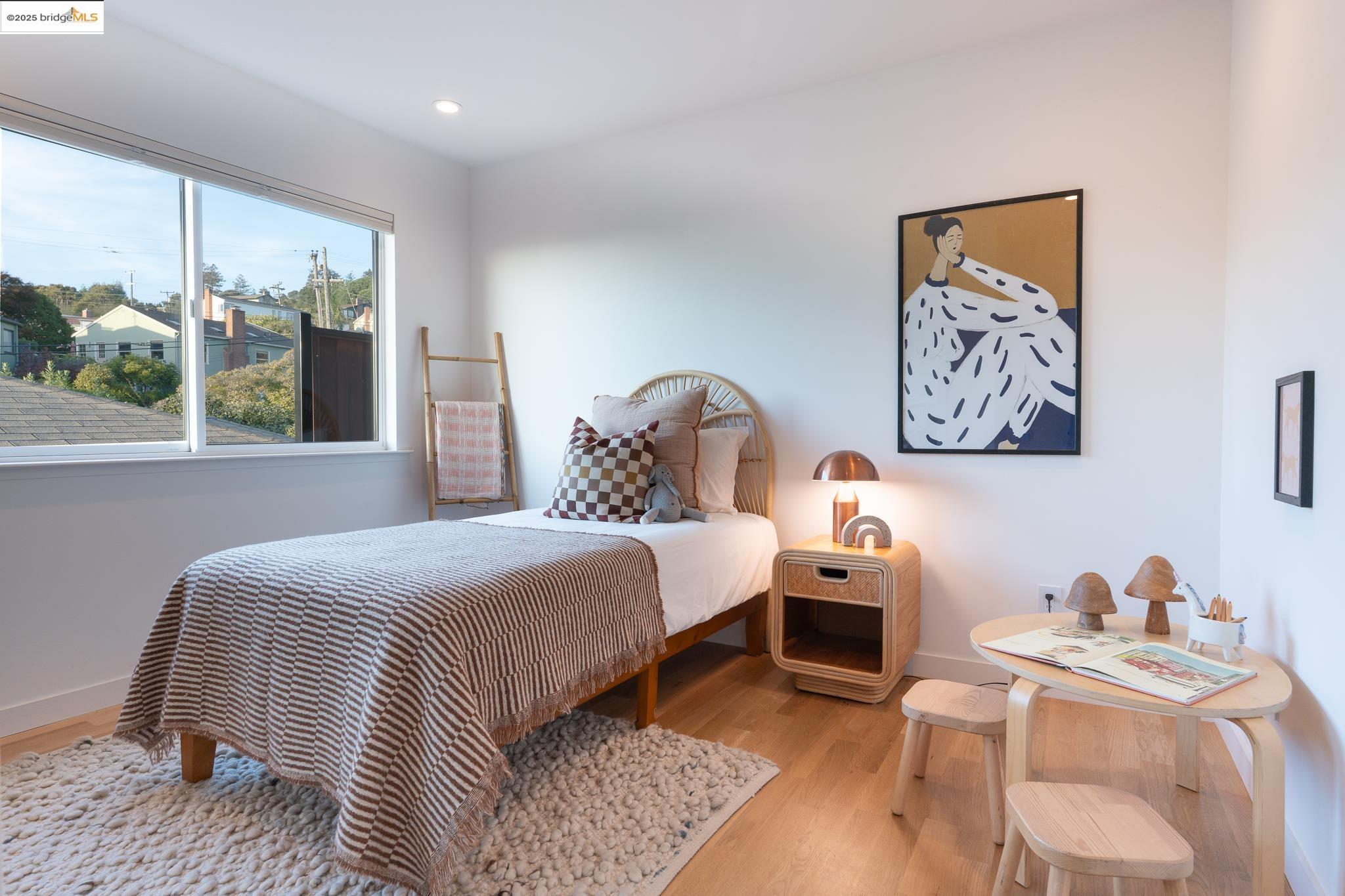 207 Cambridge Avenue Kensington, CA 94708 - Photo 28 of 47 a bedroom with a bed and wooden floor