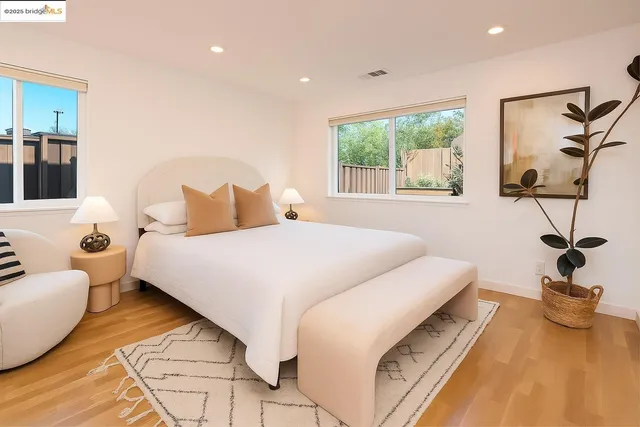 a bedroom with a bed and a large window