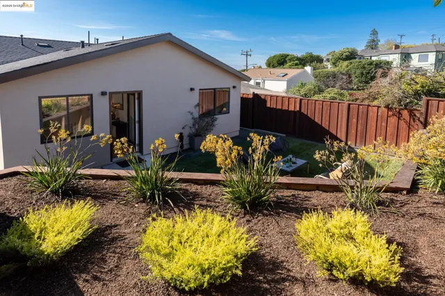 a front view of a house with a yard patio and swimming pool