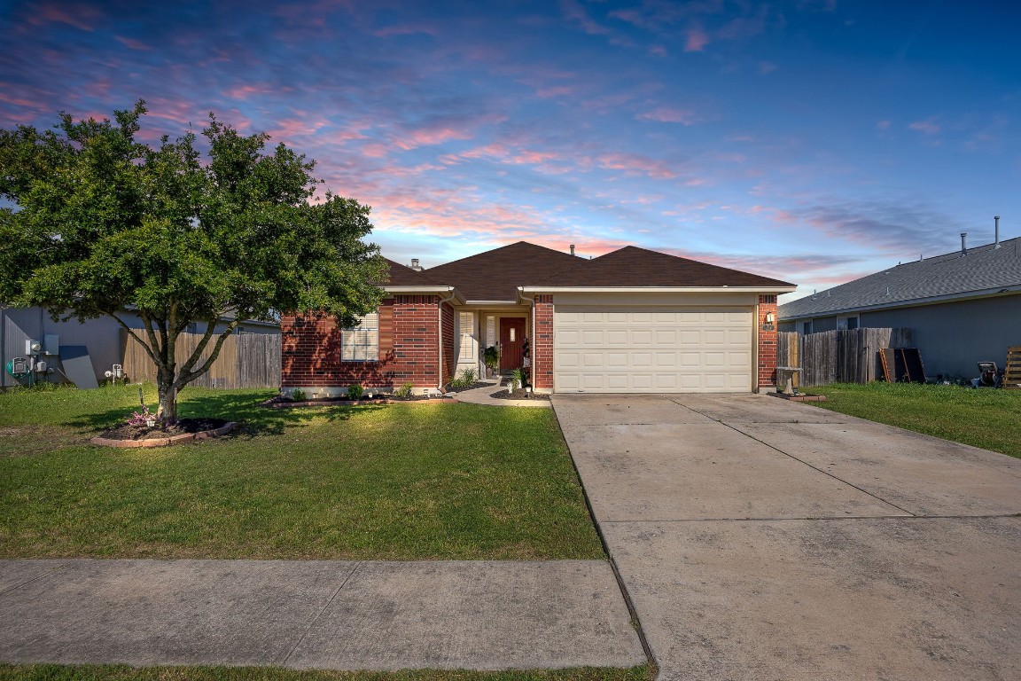 323 Mitchell Drive Hutto, TX 78634 - Photo 1 of 1 a front view of a house with a garden