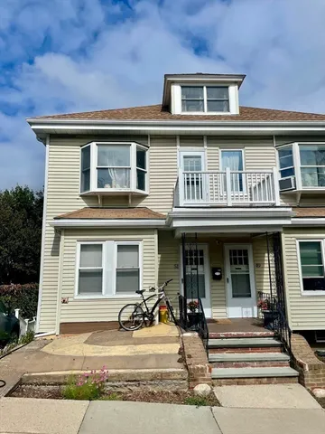 a view of a brick building with large windows