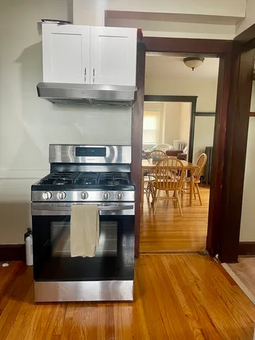 a stove top oven sitting inside of a kitchen