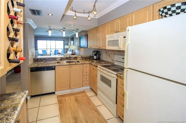 a kitchen with stainless steel appliances a stove a sink and a refrigerator