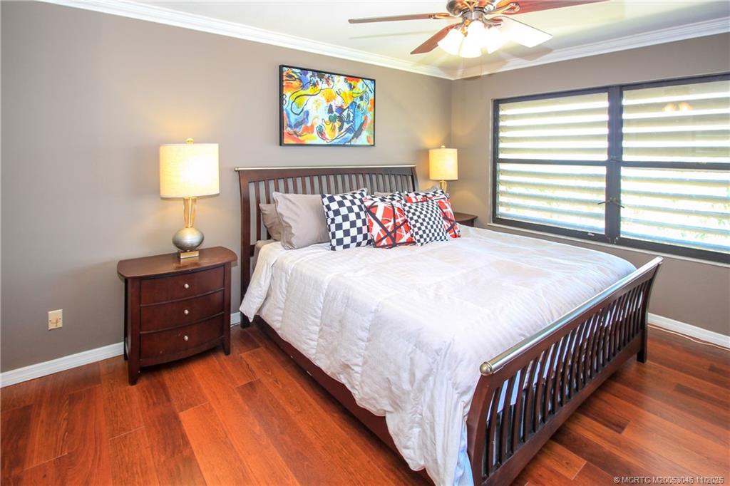 4720 Northeast Sandpebble Trace, Unit 403 Stuart, FL 34996 - Photo 14 of 40 a bedroom with a bed and a window