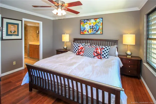 a bedroom with bed and wooden floor