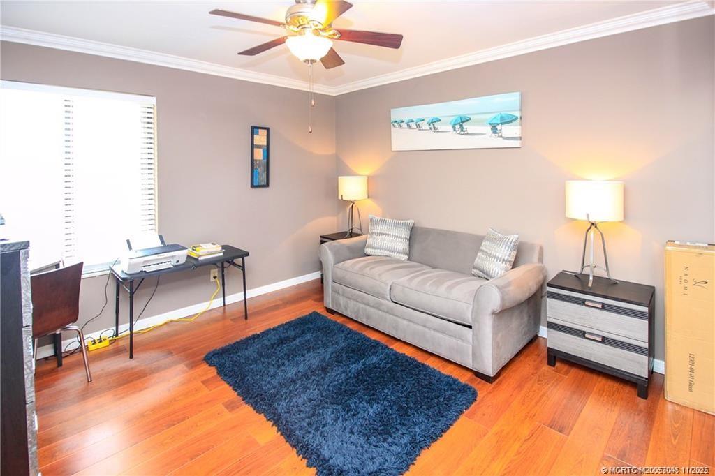 4720 Northeast Sandpebble Trace, Unit 403 Stuart, FL 34996 - Photo 19 of 40 a living room with furniture and a rug