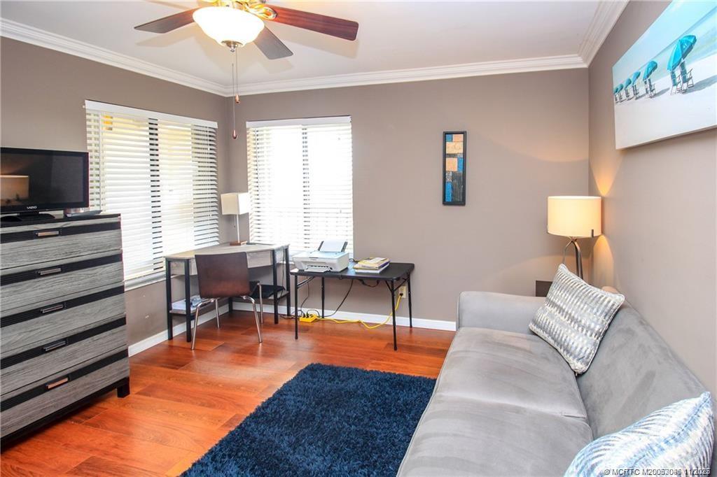 4720 Northeast Sandpebble Trace, Unit 403 Stuart, FL 34996 - Photo 20 of 40 a living room with furniture and a flat screen tv