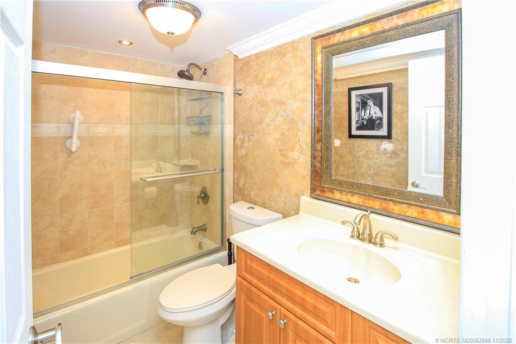 4720 Northeast Sandpebble Trace, Unit 403 Stuart, FL 34996 - Photo 21 of 40 a bathroom with a sink toilet and shower