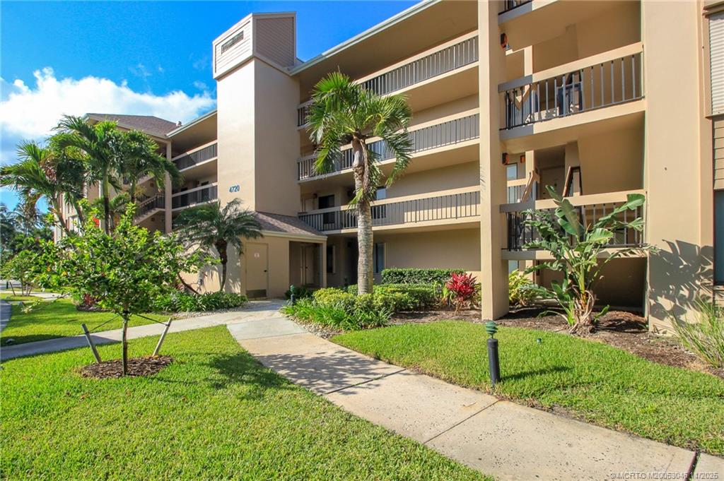 4720 Northeast Sandpebble Trace, Unit 403 Stuart, FL 34996 - Photo 29 of 40 a house view with a garden space