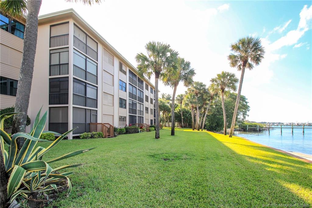 4720 Northeast Sandpebble Trace, Unit 403 Stuart, FL 34996 - Photo 31 of 40 a view of building with garden