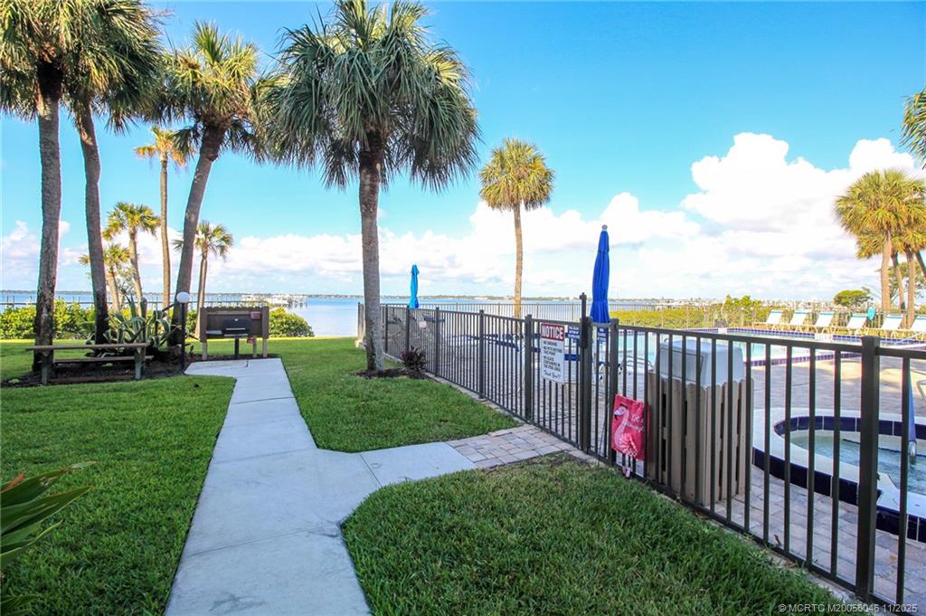 4720 Northeast Sandpebble Trace, Unit 403 Stuart, FL 34996 - Photo 34 of 40 a view of a garden with palm trees