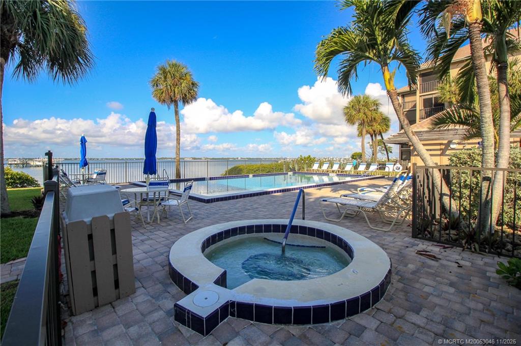 4720 Northeast Sandpebble Trace, Unit 403 Stuart, FL 34996 - Photo 35 of 40 a swimming pool with outdoor seating