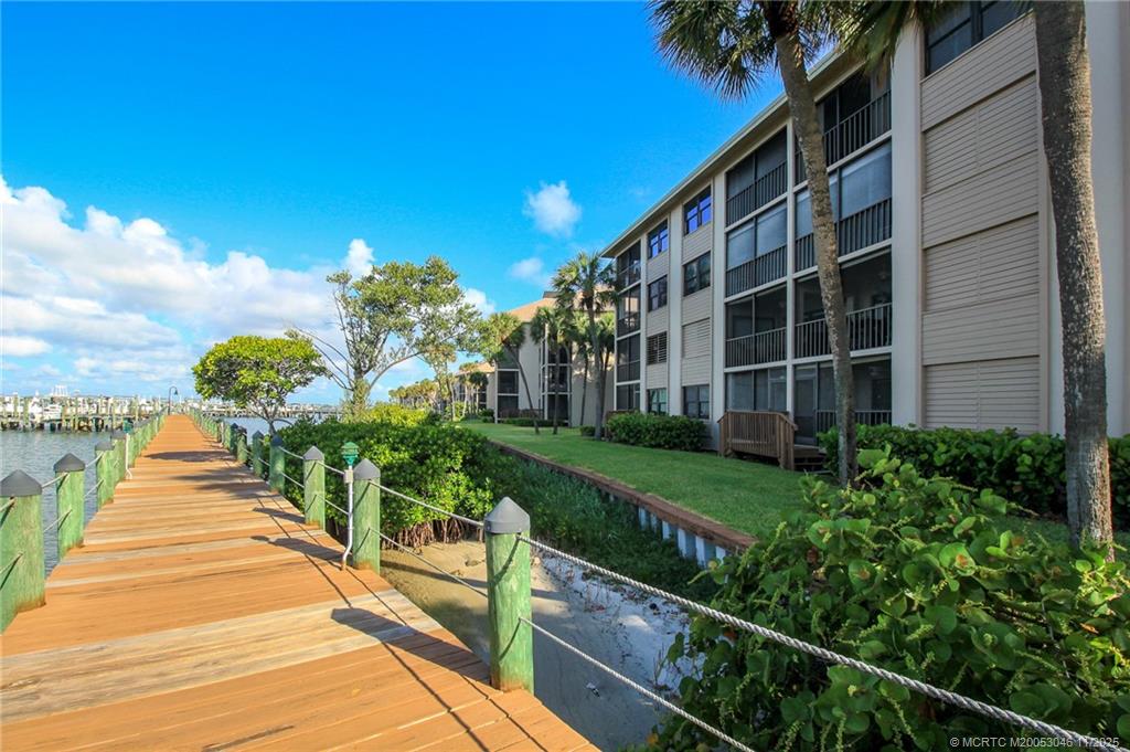 4720 Northeast Sandpebble Trace, Unit 403 Stuart, FL 34996 - Photo 37 of 40 a view of a house with a yard