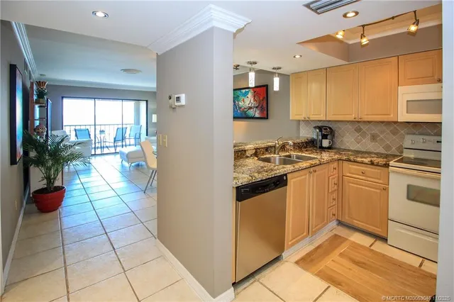 a kitchen with a sink stove and cabinets