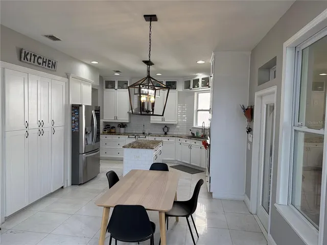 a kitchen with refrigerator and cabinets