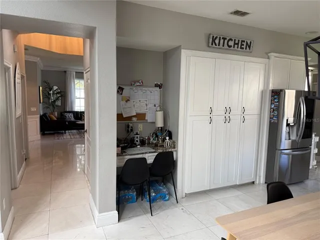 a view of kitchen with furniture and refrigerator