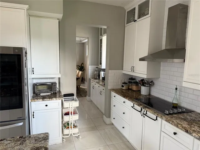 a kitchen with stainless steel appliances a sink a stove a refrigerator and cabinets