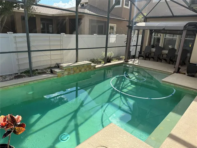 a view of a backyard with sitting area