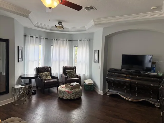 a room with wooden floor and furniture