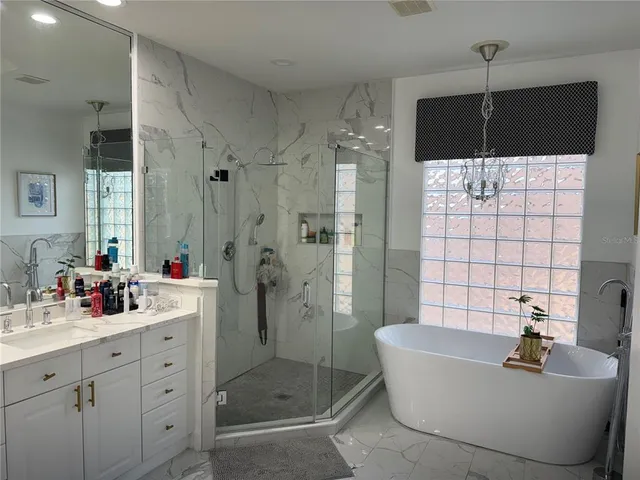 a large bed sitting in a bedroom next to a window