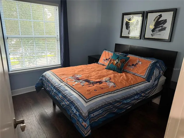 a bedroom with a bed and a window