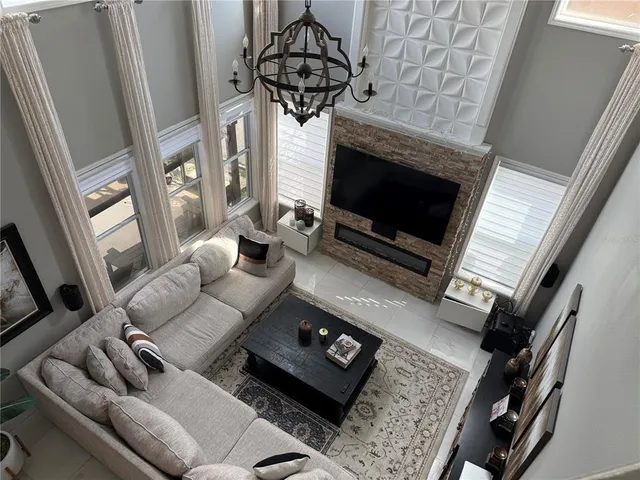 a living room with a fireplace furniture a rug and a window