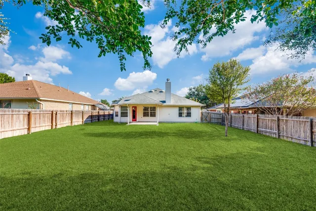 a view of a big yard with a large trees