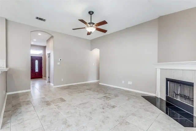a view of an empty room with a fireplace